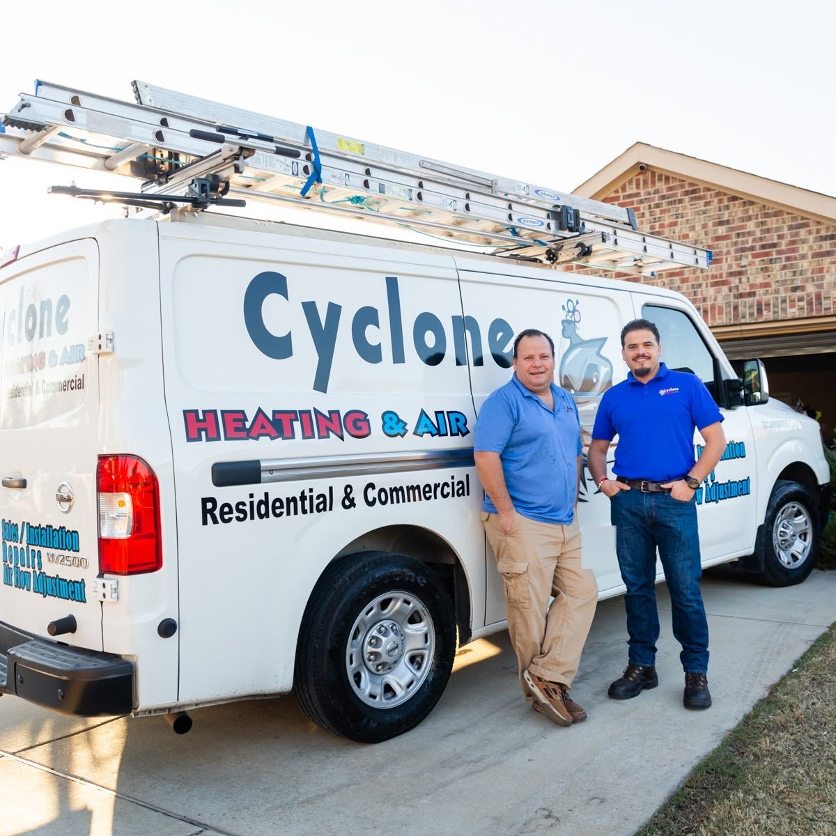The Cyclone Heating & Air crew with the service van in a customer driveway