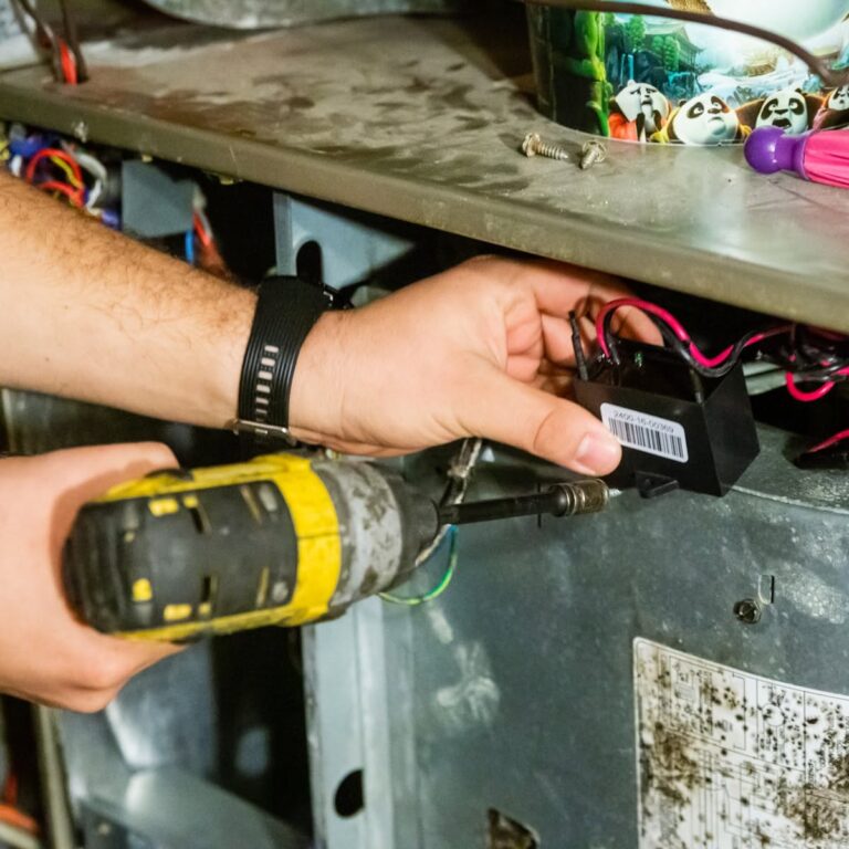 Close-up of a Cyclone technician repairing an HVAC unit