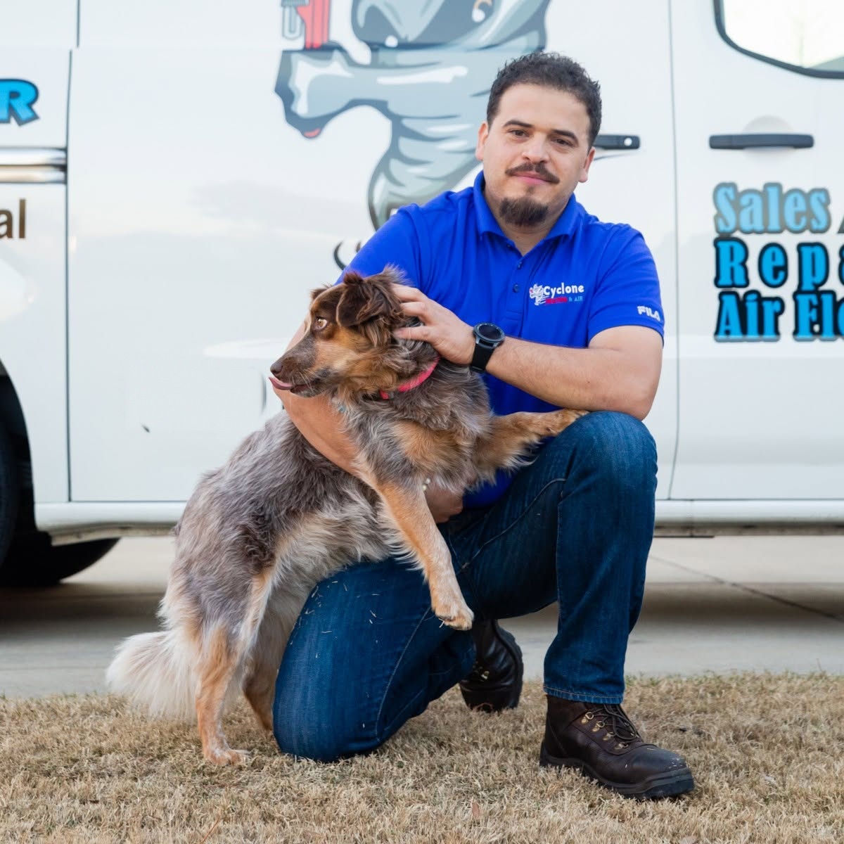 Mario, owner of Cyclone Heating & Air, with his dog beside the service van