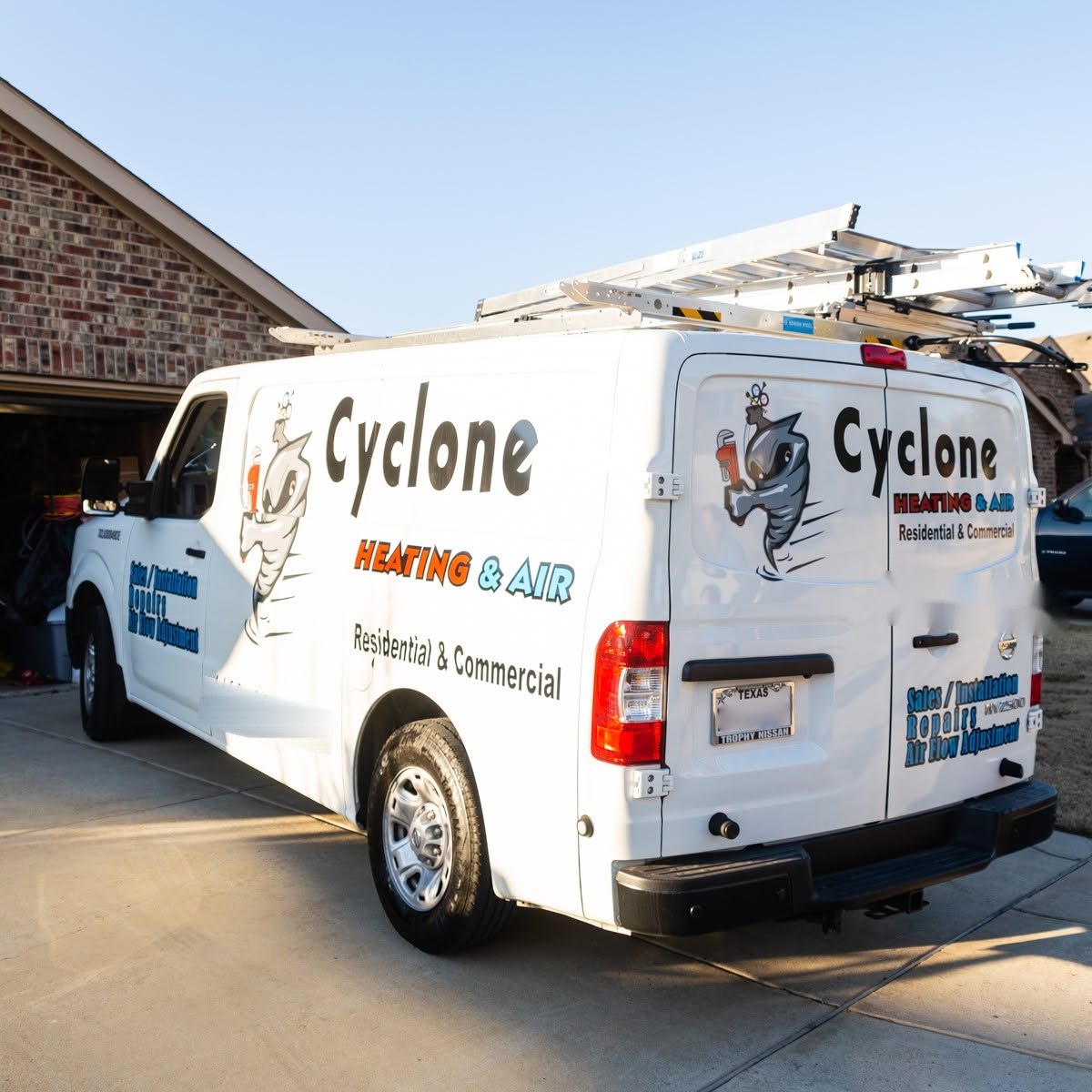 The Cyclone Heating & Air service van leaving a driveway